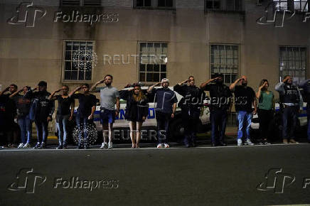 NYPD officers salute for the ambulance transfer of slain NYPD officer Didarul Islam, in New York City