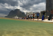 People attend a symbolic ritual named ?O Abraco' marking the World Oceans Day, at Sao Conrado beach in Rio de Janeiro