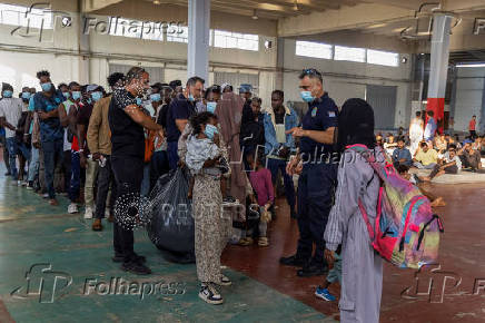 Newly-arrived migrants prepare to depart to mainland Greece, from Crete island