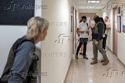 A migrant is detained by federal immigration officers at U.S. immigration court