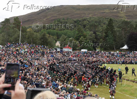 Members of a Pipe band march during the Braemar Royal Highland Gathering at the Princess Royal and Duke of Fife Memorial Park in Braemar