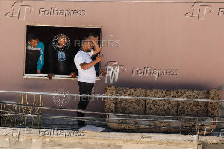 Palestinians carry their belongings after Israel's decision to demolish their homes in Nur Shams camp