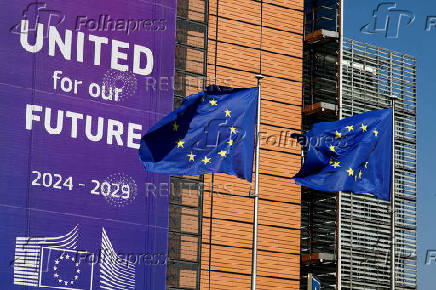 FILE PHOTO: European Union flags flutter outside the European Commission headquarters in Brussels