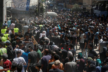 Palestinians gather to receive aid at a distribution center, in Gaza City