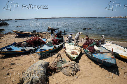Palestinian fishermen react after Israeli military reiterated an order banning them from entering the sea, in Gaza City