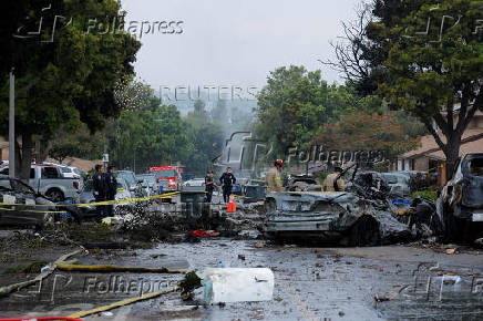 Crash scene after a civilian aircraft went down in a neighborhood, in San Diego