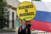 Activists of Greenpeace attend a protest near the Russian Embassy in Paris