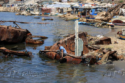 Palestinian fishermen react after Israeli military reiterated an order banning them from entering the sea, in Gaza City