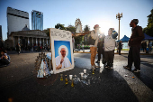 People stand next to a picture of the late Pope Francis, in Buenos Aires