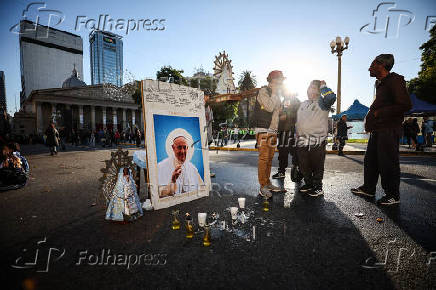 People stand next to a picture of the late Pope Francis, in Buenos Aires