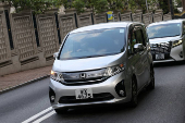 Vans believed to be carrying former Hong Kong lawmaker Claudia Mo arrive at her residence after she served a four-year and two-month sentence for conspiracy to commit subversion in a landmark national security case, in Hong Kong
