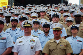 U.S. Navy sailors line up for a group portrait in Times Square during Fleet Week 2025