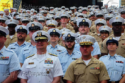 U.S. Navy sailors line up for a group portrait in Times Square during Fleet Week 2025