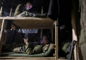 Servicemen of the Ukrainian Armed Forces rest in a dugout at a front line in Donetsk region