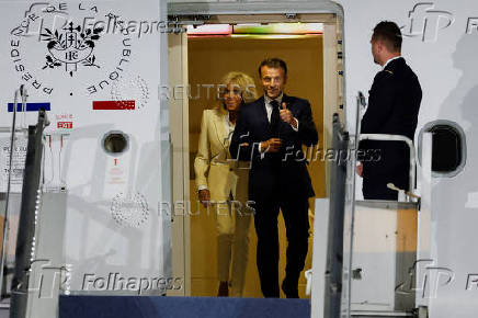 French President Emmanuel Macron and his wife, Brigitte Macron arrive at military airbase Halim Perdanakusuma in Jakarta