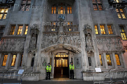 FILE PHOTO: Police officers stand on duty outside the Supreme Court in Parliament Square, central London