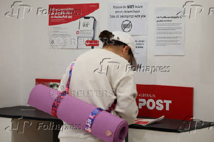 FILE PHOTO: A notice about United States tariffs is displayed inside an Australia Post office in Sydney