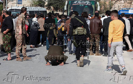 A detainee prostrates on the ground after being released today in Aleppo