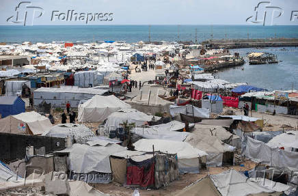 Palestinians displaced by the Israeli military offensive shelter in tents, in Gaza City