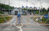 Finnish Border Guard at the barrier fence between Finland and Russia