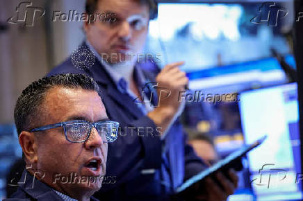 Traders work on the floor of the NYSE in New York