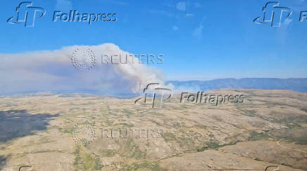 An aerial view shows smoke rising from a wildfire in Navaluenga