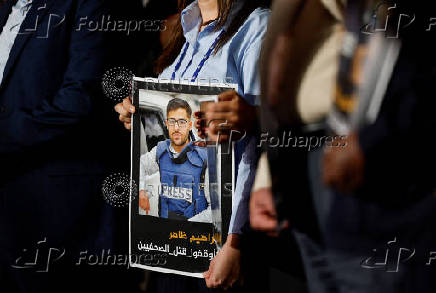 Al Jazeera staff members gather at the network?s studios to remember their colleagues killed in Gaza City by an Israeli strike, in Doha