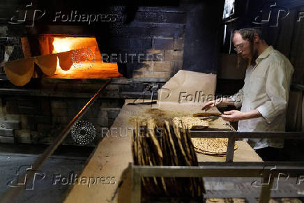 Ultra-Orthodox Jews prepare matza for the upcoming Jewish holiday of Passover