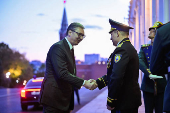 Serbian President Aleksandar Vucic shakes hands as he arrives for a meeting with Russian President Vladimir Putin at the Kremlin in Moscow