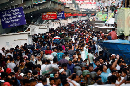 People board passenger ferries as they leave to celebrate Eid al-Adha with their families, in Dhaka