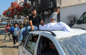 Mourners attend the funeral of Palestinians who were killed, according to medics, in Israeli fire, at Al-Shifa hospital, in Gaza City