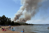 Wildfire burns in the village of Vourvourou
