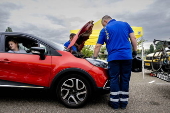 Vacationers have their vehicles checked at the border crossing with Belgium