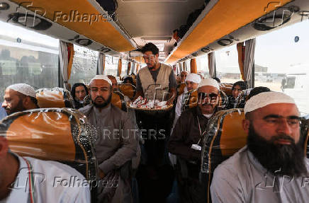 Iranian pilgrims who were rerouted through Iraq is pictured inside a bus at the Arar border crossing