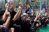 Shi'ite mourners raise their hands and shout slogans during during a Muharram procession ahead of Ashura in Srinagar