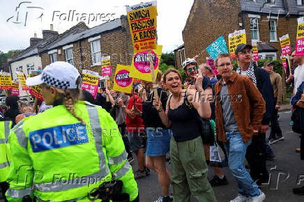 Anti-racism protesters attend a counter protest, on the day of anti-immigration demonstrations outside the Bell Hotel in Epping