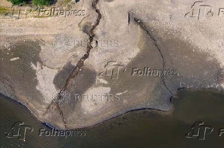 A drone view shows a partially dried section of the Jumbles Reservoir near Blackburn