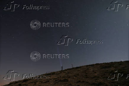 A meteor streaks across the sky, in Qamishli