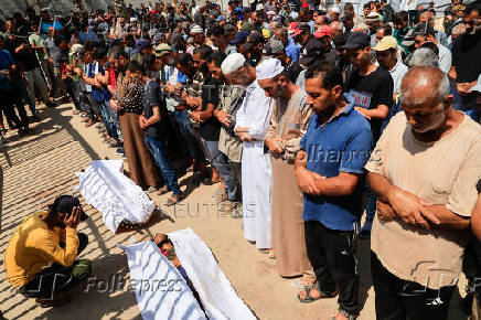 Mourners pray during the funeral of Palestinians killed in what the Gaza Health Ministry said were Israeli airstrikes, in Khan Younis