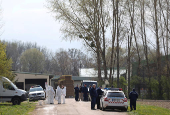 Members of the epidemic authorities and Hungarian police wait front of a farm during the outbreak of foot-and-mouth disease in Dunakiliti