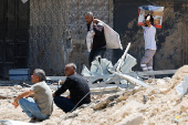 Palestinians carry their belongings after Israel's decision to demolish their homes in Nur Shams camp