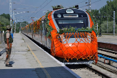 A security force personnel stands guard as India's high-speed train 