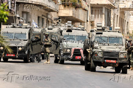 Israeli soldiers take part in an Israeli raid in Nablus