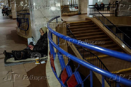 People take shelter inside a metro station during a Russian military strike in Kyiv