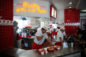 Workers serve customers at In-N-Out Burger outlet in Los Angeles
