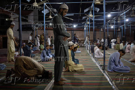 Students participate in Fajr prayer at a madrasa in Multan