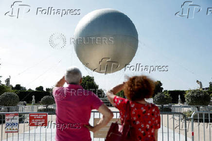 The return of a new Paris 2024 flame cauldron set on a balloon to the Tuileries Garden and the Paris skyline