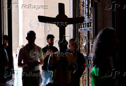 Young pilgrims pass through the Holy Door of St. Peter's Basilica during Jubilee of Youth, at the Vatican