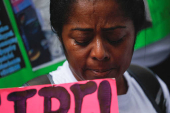 Family members of migrants imprisoned in El Salvador protest outside the United Nations building, in Caracas