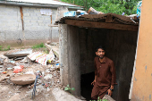 Faizan Anayat, 22, an air-conditioner mechanic, comes out of a bunker, that was build for the safety of his family, to protect them from the cross-border shelling, in Chakothi Village